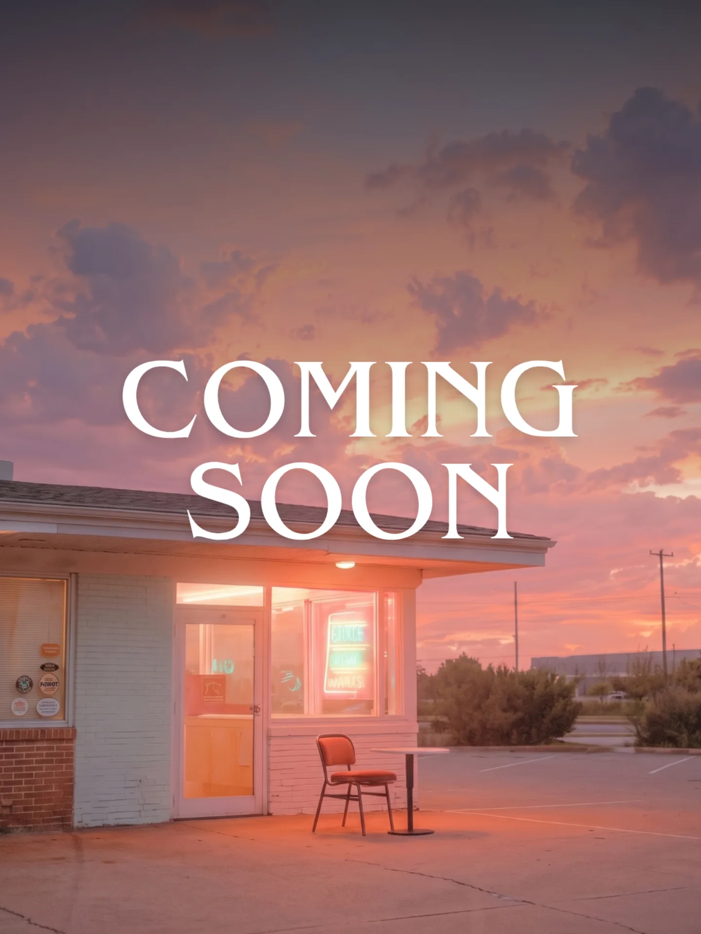 Coming Soon over a roadside cafe under a pink evening sky